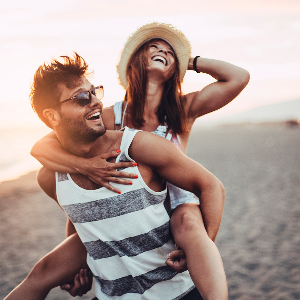 Young couple laughing on the beach